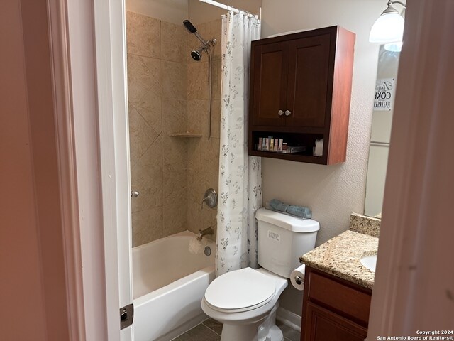 full bathroom featuring tile patterned floors, vanity, shower / bath combo, and toilet