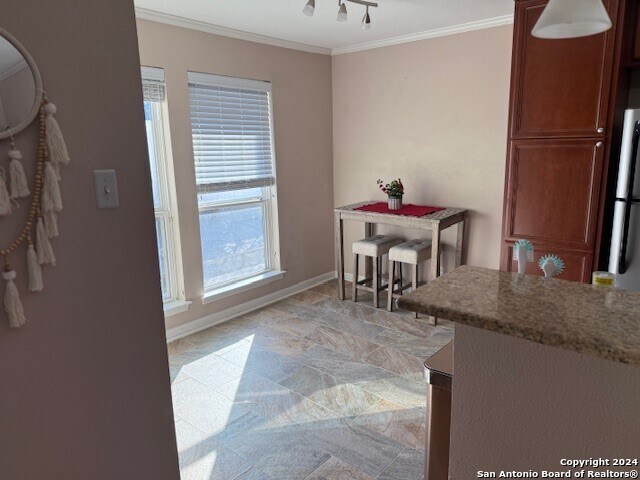 dining room featuring crown molding