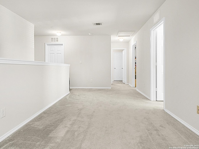 hallway with light colored carpet