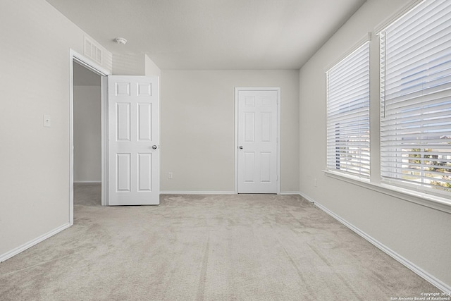 empty room with light colored carpet