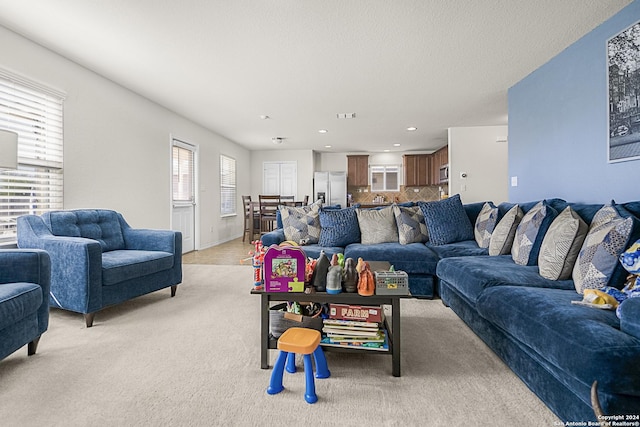 carpeted living room featuring a textured ceiling