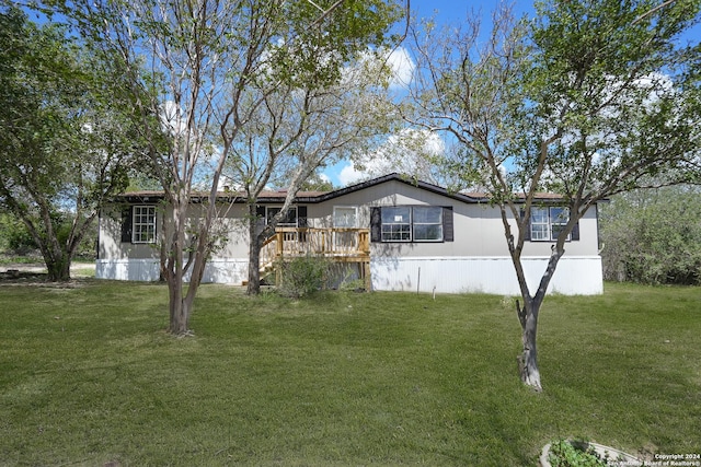 view of front of house featuring a deck and a front yard