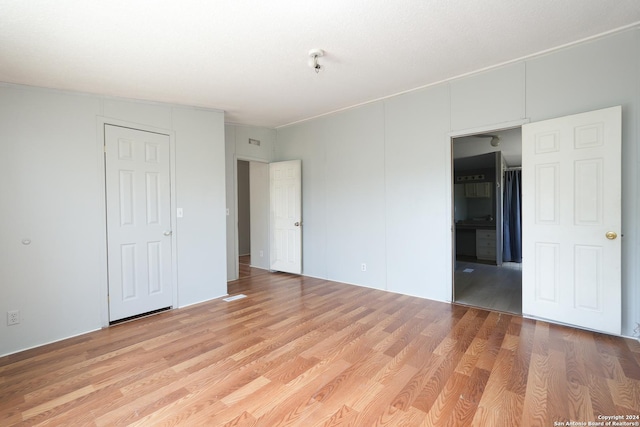 unfurnished bedroom with light wood-type flooring