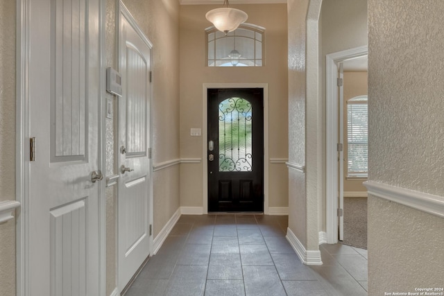 tiled entryway featuring vaulted ceiling