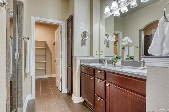 bathroom featuring vanity and an enclosed shower