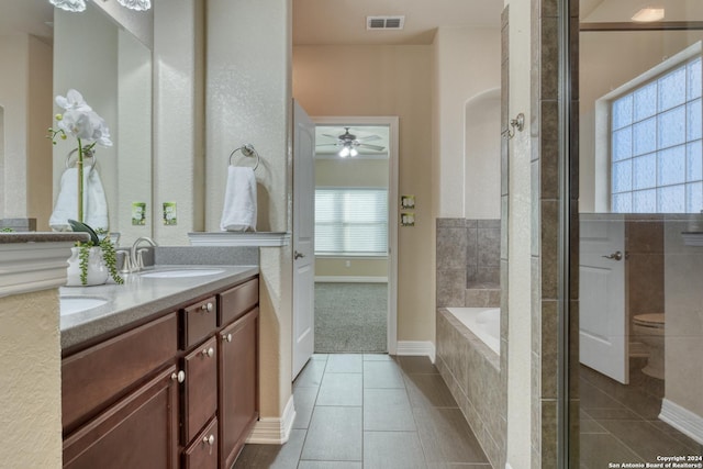 bathroom with tile patterned flooring, ceiling fan, vanity, and a wealth of natural light