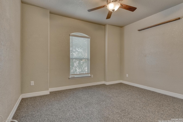 empty room with a textured ceiling, carpet floors, and ceiling fan