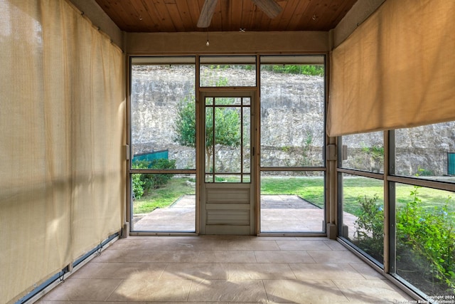 unfurnished sunroom with ceiling fan and wood ceiling