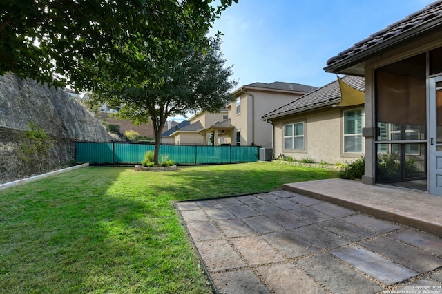 view of yard featuring cooling unit and a patio area