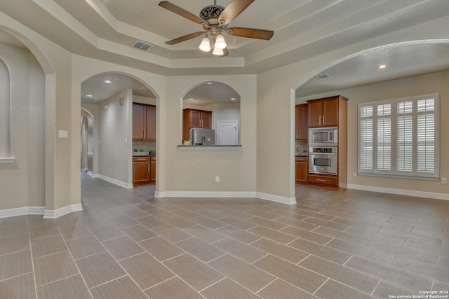 unfurnished living room with ceiling fan