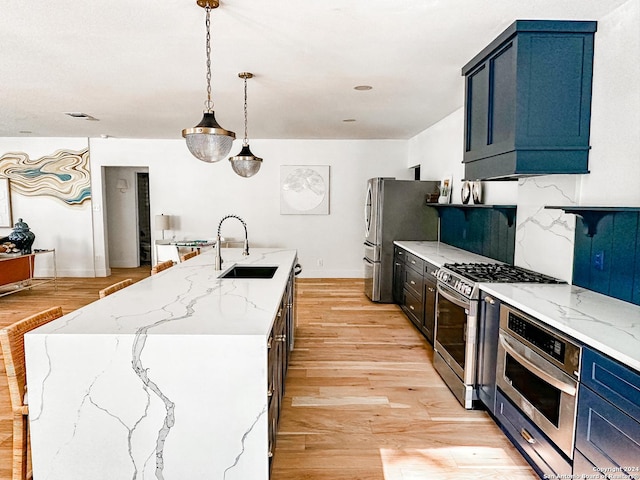 kitchen with decorative light fixtures, stainless steel appliances, blue cabinets, and sink