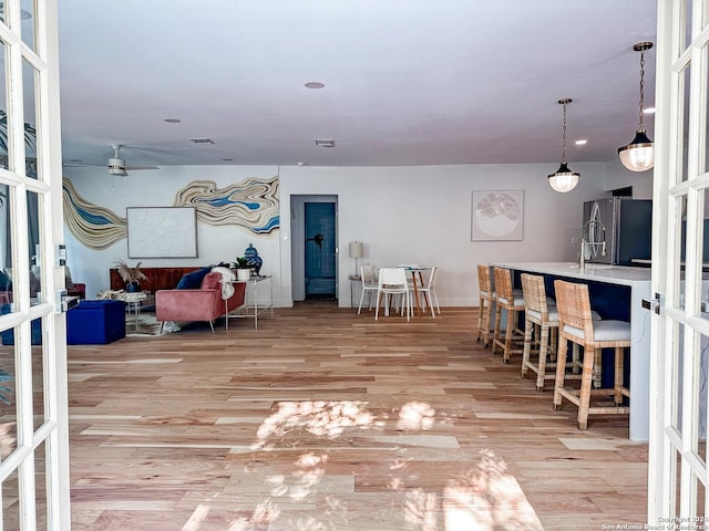 interior space featuring ceiling fan, light hardwood / wood-style floors, and french doors