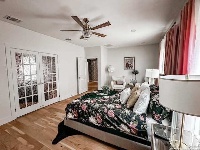 bedroom featuring ceiling fan, light wood-type flooring, and french doors