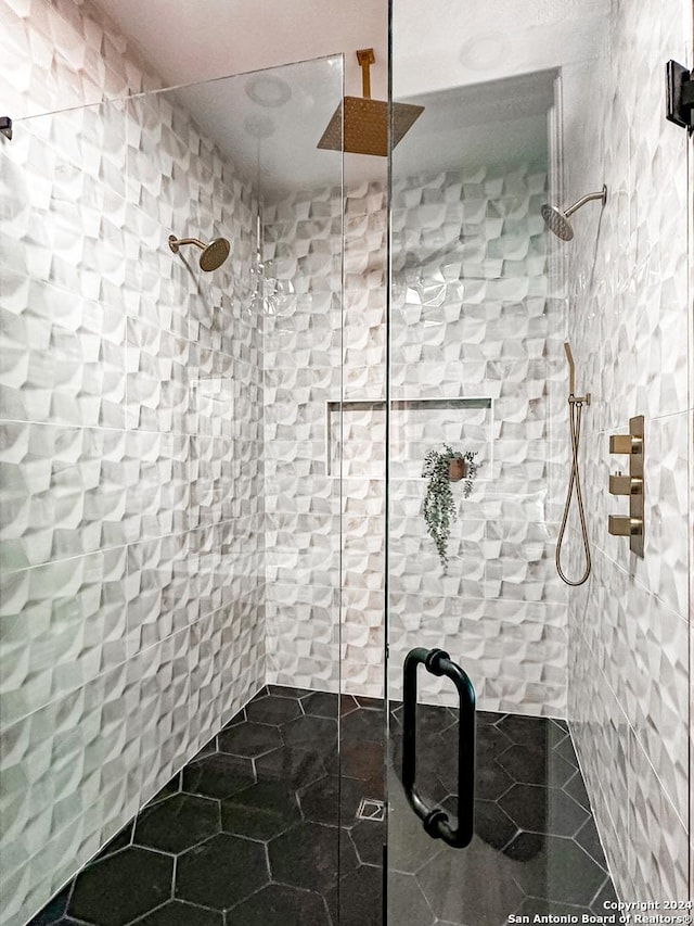 bathroom featuring tile patterned floors and a shower with door