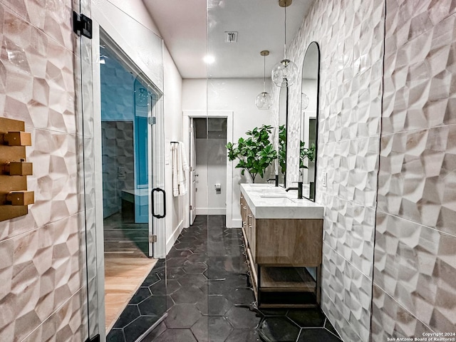 bathroom featuring vanity and tile walls