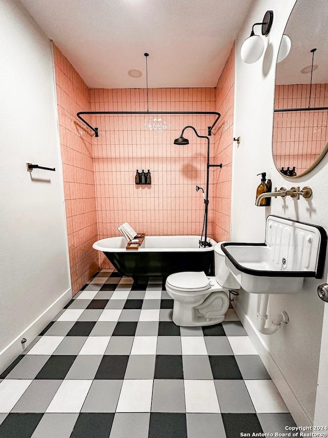 bathroom featuring a textured ceiling, tile walls, tiled shower / bath combo, and toilet