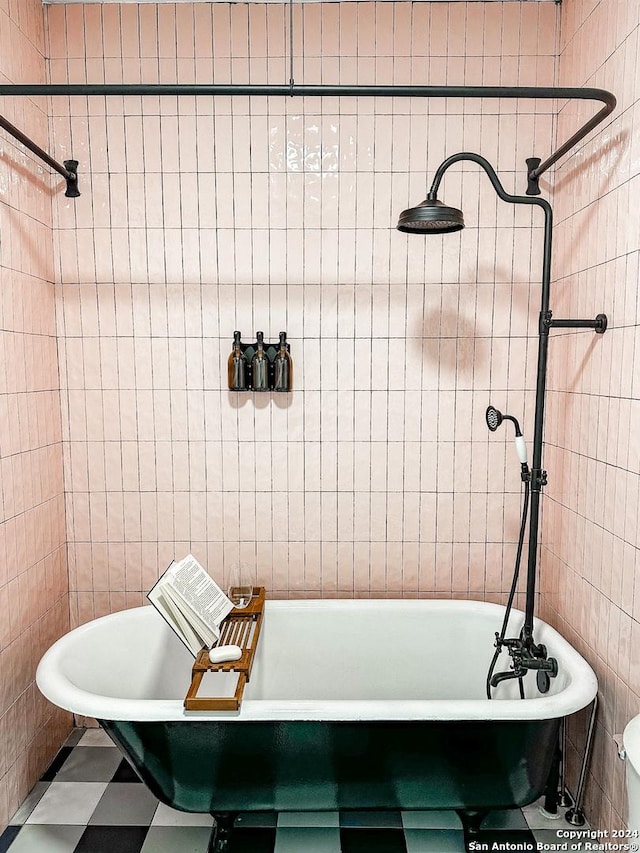 bathroom with a bathtub and tile walls