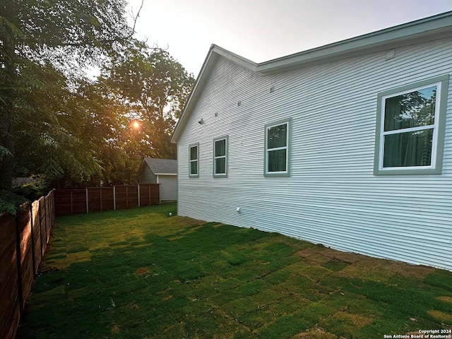 view of property exterior featuring a lawn