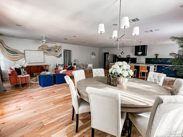 dining space with wood-type flooring and ceiling fan