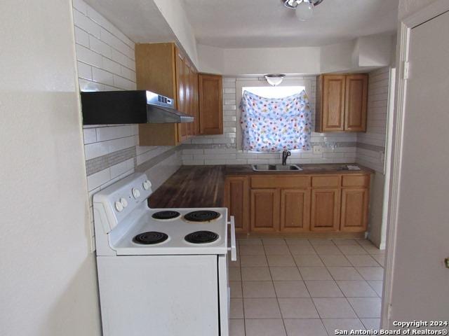 kitchen with backsplash, ventilation hood, sink, light tile patterned floors, and white electric range