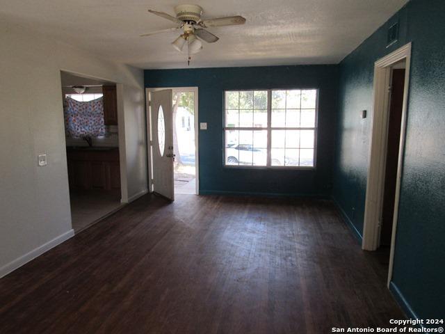 entryway with ceiling fan and dark hardwood / wood-style flooring