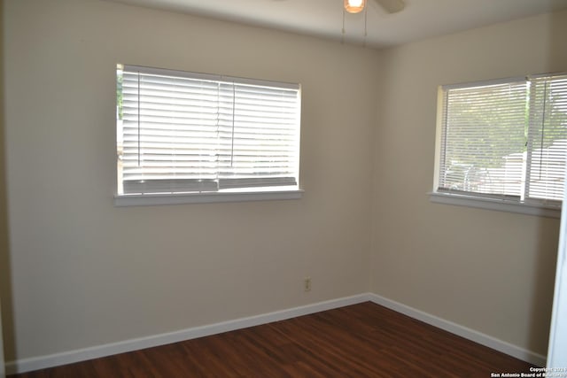 spare room featuring ceiling fan and dark hardwood / wood-style flooring