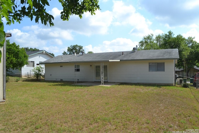 back of property featuring a lawn and a patio