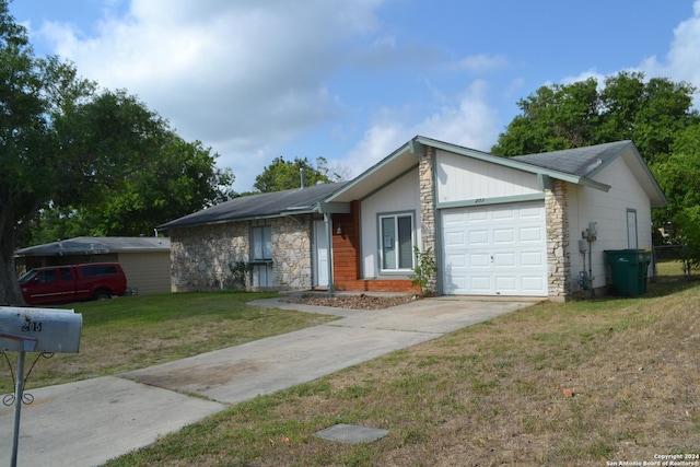 ranch-style home featuring a garage and a front lawn