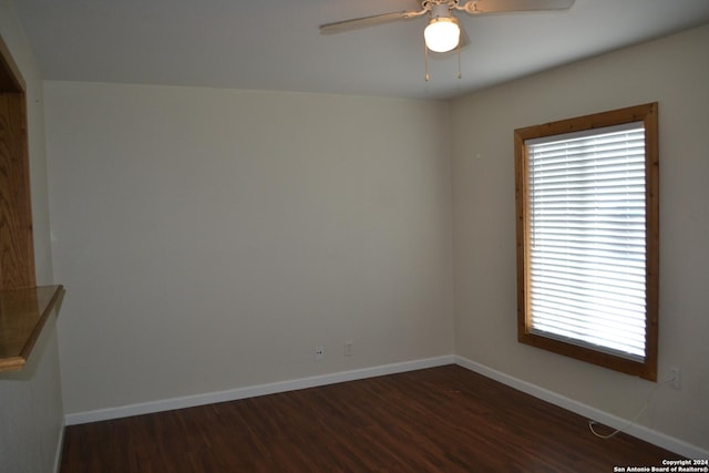 unfurnished room featuring ceiling fan and dark wood-type flooring