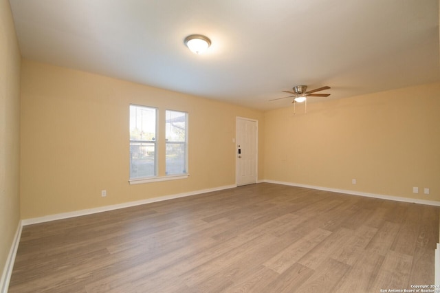 spare room featuring hardwood / wood-style floors and ceiling fan