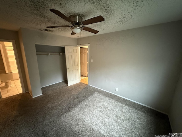 unfurnished bedroom with carpet, ensuite bath, ceiling fan, a textured ceiling, and a closet