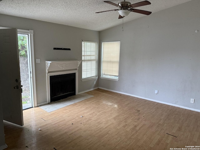 unfurnished living room with a wealth of natural light and light hardwood / wood-style flooring