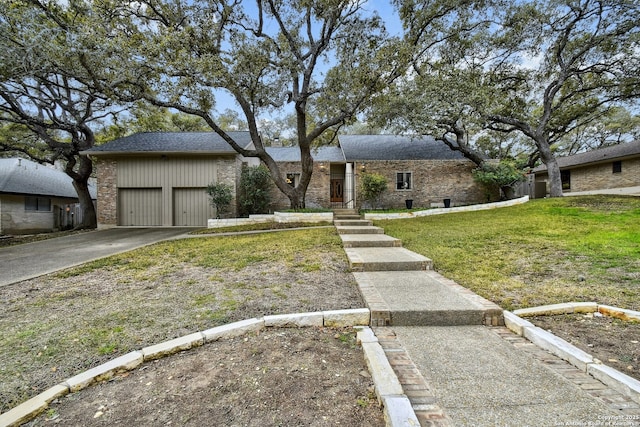 view of front of property featuring a garage and a front lawn