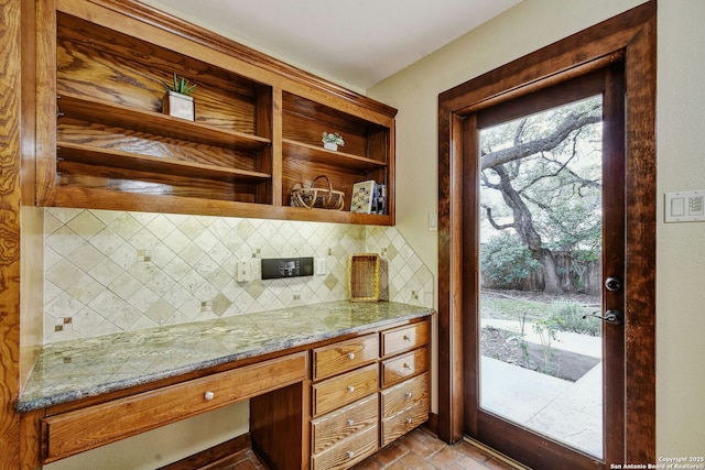 kitchen featuring tasteful backsplash and light stone countertops