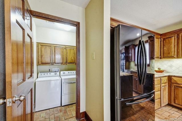 laundry area with cabinets and washing machine and clothes dryer