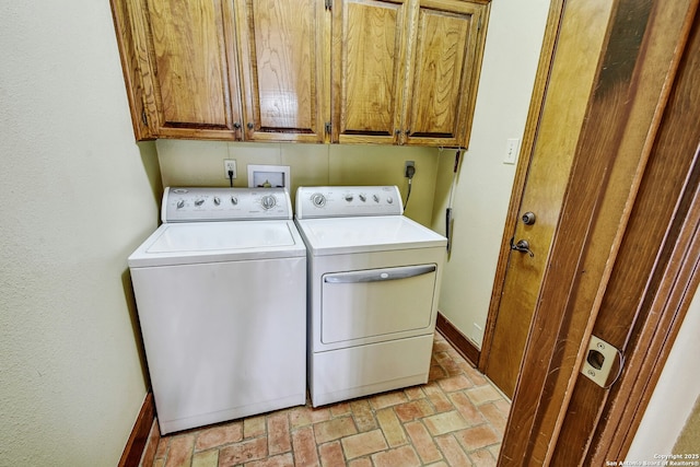 laundry area featuring separate washer and dryer and cabinets