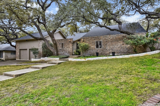 view of front of home with a front lawn and a garage