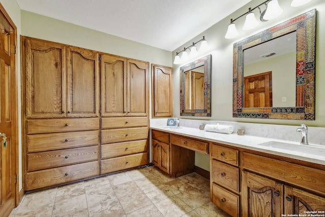 bathroom featuring vanity and a textured ceiling