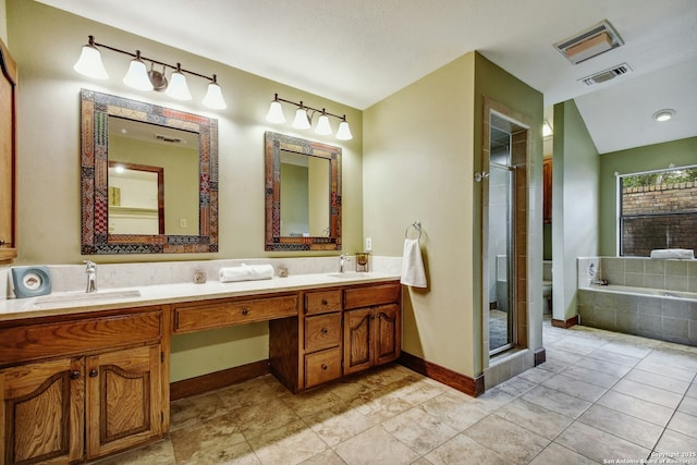 full bathroom featuring toilet, vanity, and independent shower and bath