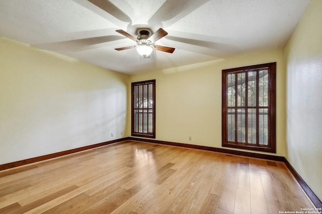 unfurnished room featuring ceiling fan, hardwood / wood-style floors, and a textured ceiling