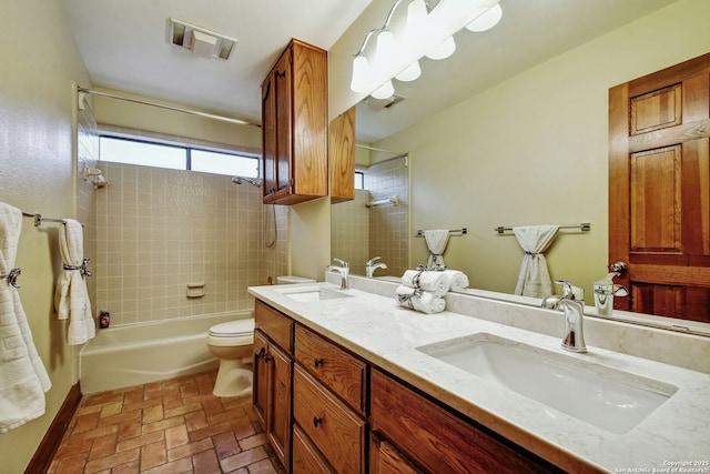 full bathroom featuring toilet, vanity, and tiled shower / bath combo