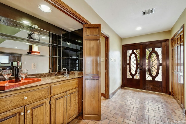 bar featuring sink and french doors