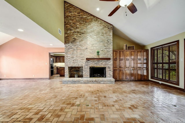 unfurnished living room with high vaulted ceiling, a brick fireplace, and ceiling fan