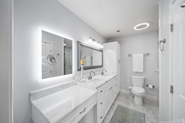 bathroom featuring vanity, toilet, and an enclosed shower