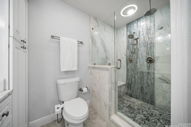 bathroom with toilet and an enclosed shower