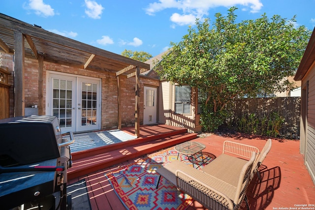 wooden terrace with french doors and a pergola