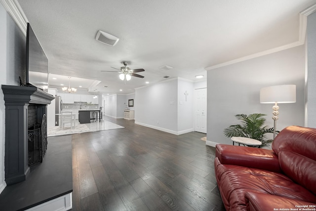 living room with a textured ceiling, ceiling fan with notable chandelier, dark hardwood / wood-style flooring, and crown molding