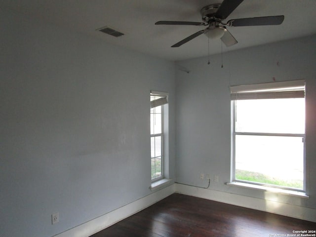 empty room with ceiling fan and dark wood-type flooring