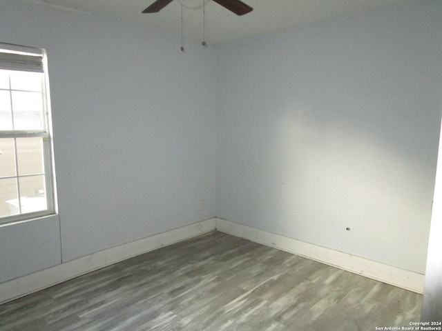 spare room featuring hardwood / wood-style floors, ceiling fan, and a wealth of natural light