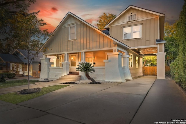 view of front of home with a carport and a porch